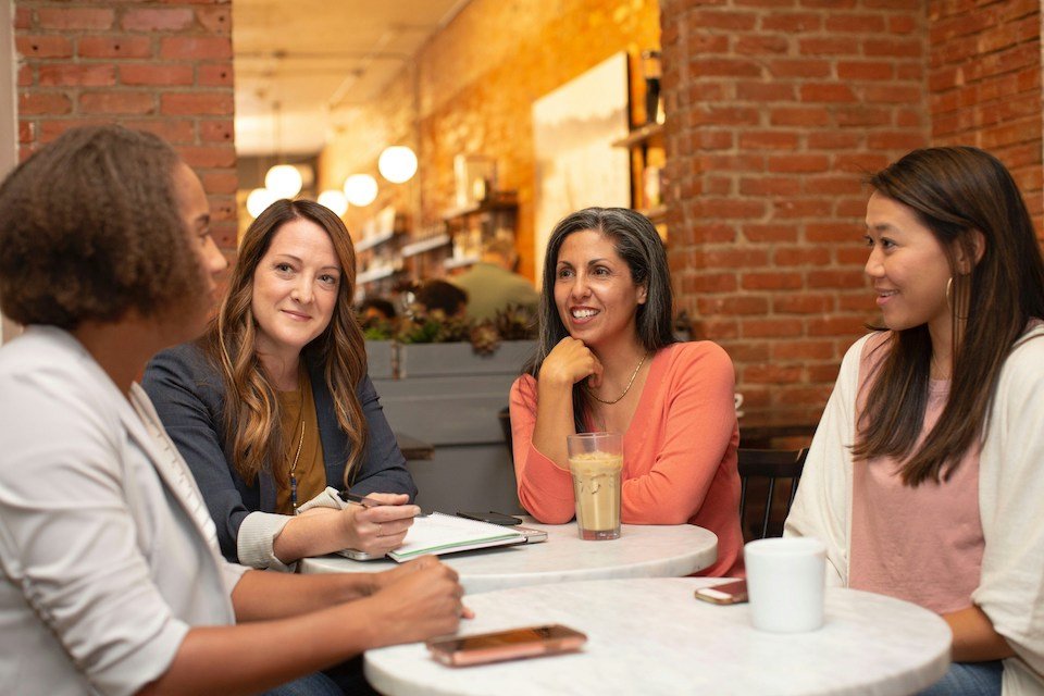 Guests holding drinks and networking at a social gathering